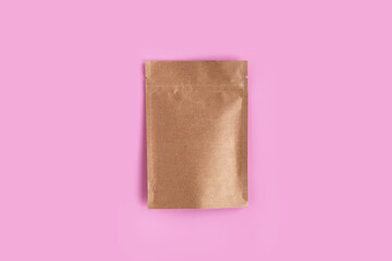 Kraft brown paper empty bags isolated mock up on light pink background. Eco friendly pack with zipper, roasted specialty coffee beans, tea, snack, alternative sample trendy concept. top view, flat lay