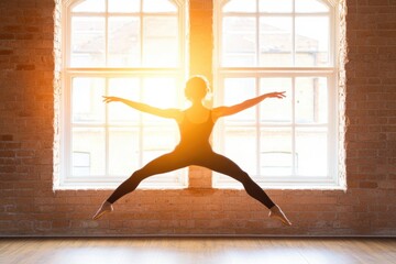 Silhouette of female ballet dancer leaping in sunlit room