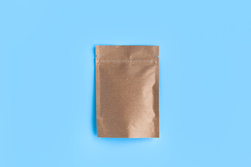 Kraft brown paper empty bags isolated mock up on light blue background. Eco friendly pack with zipper, roasted specialty coffee beans, tea, snack, alternative sample trendy concept. top view, flat lay