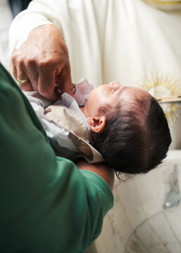 Baby receiving blessings at her christening