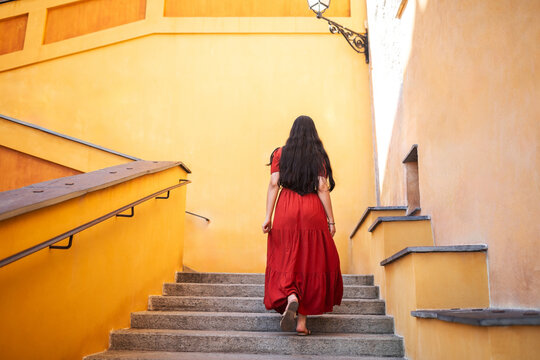 Asian woman climbing stairs in the city
