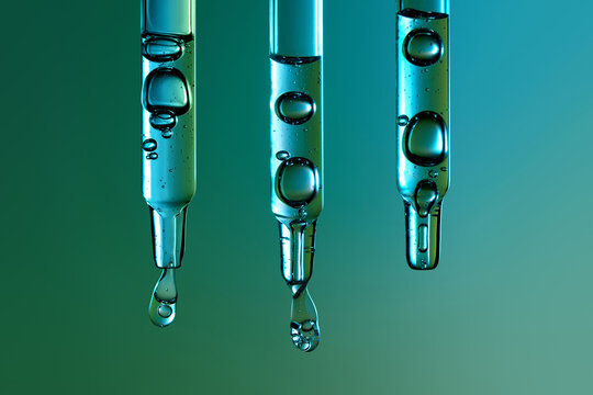 Three glass pipettes with drops of cosmetic product falling down. 