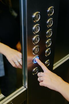 Unrecognisable Person Pressing the Elevator Button