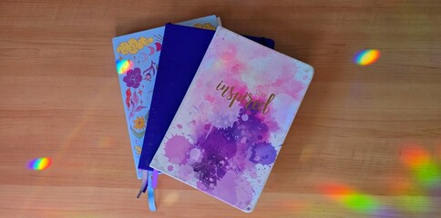 Journals on desk with rainbow lighting