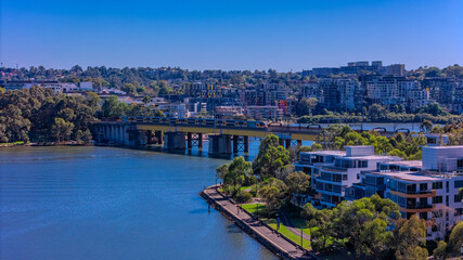 Fototapeta premium Panorama Aerial view above Rhodes with views to Meadowbank and Olympic park and Wentworth Point and Concord West with Parramatta River in Sydney NSW Australia