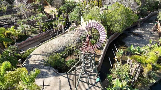 Colorful wind spinner rotating in the wind as a decorative garden ornament.