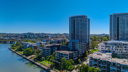 Fototapeta premium Panorama Aerial view above Rhodes with views to Meadowbank and Olympic park and Wentworth Point and Concord West with Parramatta River in Sydney NSW Australia