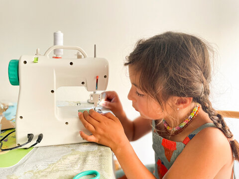 A young girl  sewing 