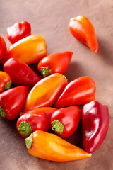 Fresh Organic Bell Peppers in Farm-to-Table on Brown Clay Surface