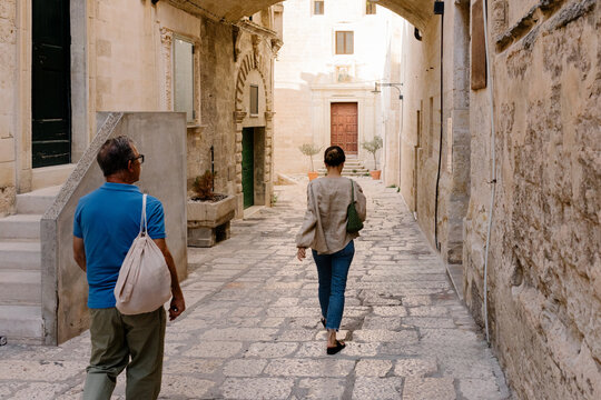 Father and daughter stroll in Matera during a vacation trip in Italy