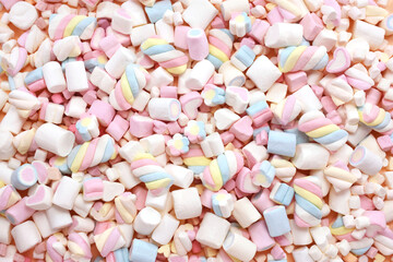 Confectionery and sweeties varieties background: light pink and white marshmallows, sugar confetti, bonbon and candies