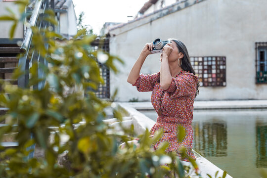 Woman photographer using analog film camera