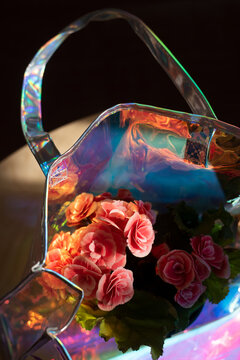 Iridescent bag with begonia flowers inside