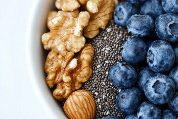 Obraz premium A bowl of nuts, blueberries, and chia seeds