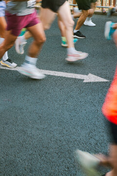 Motion blur shot of runners with arrow on the ground 