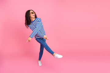 Full body portrait of nice young girl dance empty space isolated on pink color background