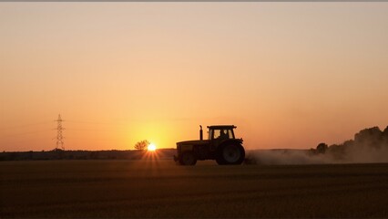 Fototapeta premium tractor at sunset
