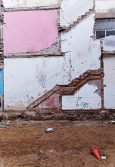 demolition background, side walls of a residential building with traces of floors and stair