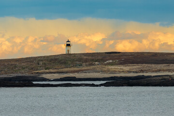 Maine Lighthouse in front of puffy clouds