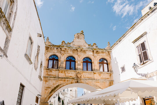 A rustic archway crossing a street of the town of Ostuni in Apulia