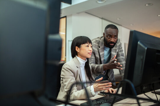Diverse business people working together on office computer