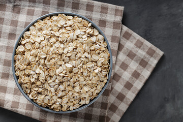 Dry Oatmeal in Bowl on Linen Napkin, Close-Up