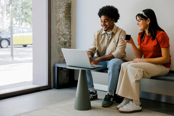 Young professionals collaborating on laptop in modern office space