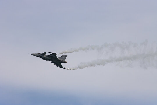 F 16 fighter jet in action, airplane flying against the background of the blue sky, plane in flight, plane in an air show formation, May 5, 2024, Caorle, Italy.