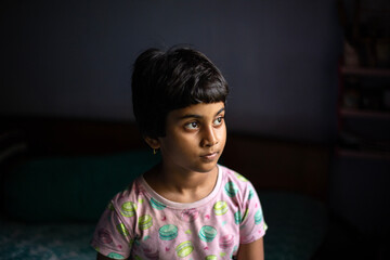 Portrait of a little girl inside home