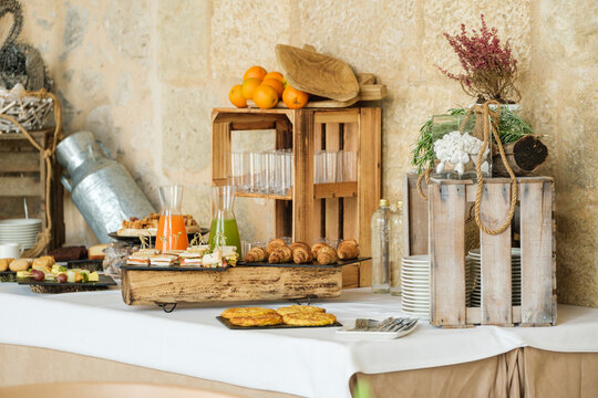 Elegant rustic buffet setup with fresh produce and pastries