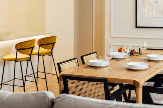 Elegant modern dining setup with wooden table and chairs