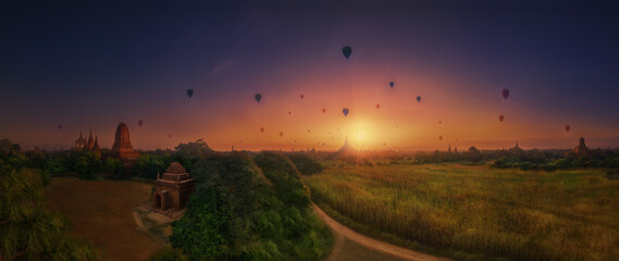 Magical sunrise over ancient temples with floating balloons