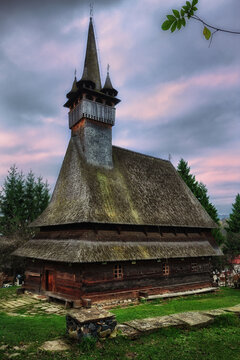Sunrise over traditional wooden church in Sapanta, Romania