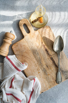 Top view of rustic kitchen table with utensils and oil