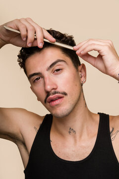 man combing his hair in a beauty routine