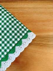 Folded cloth napkin on the wooden table with copy space.