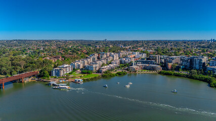 Fototapeta premium Panorama Aerial view above Rhodes with views to Meadowbank and Olympic park and Wentworth Point and Concord West with Parramatta River in Sydney NSW Australia