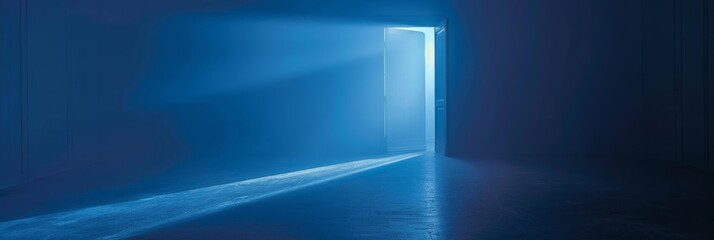 A solitary open door emits light in a dark, minimalist space.