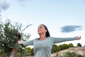 Serene Woman in Uplifting Connection with Nature