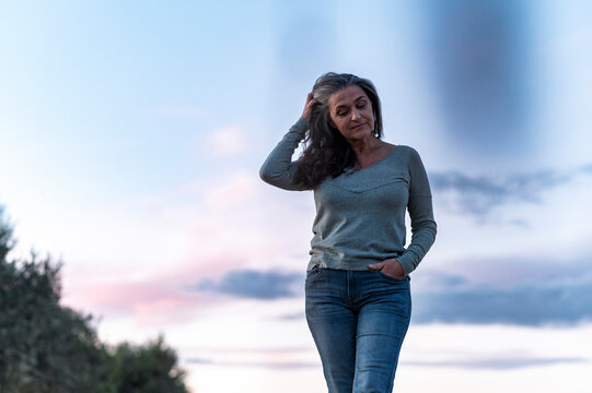 Pensive woman walks alone in deep thoughts