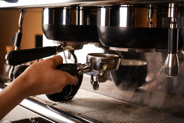 The barista is already eager to make coffee. With the help of a coffee machine. Close-up photo.