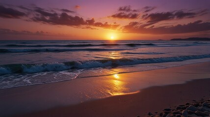 Fototapeta premium Dramatic sunset over a tranquil beach, with waves gently lapping the shore. Colorful clouds fill the sky above the horizon as the sun dips below the ocean. Soft light reflects on the water and sand.