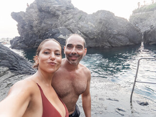 ugc selfie of tourist couple bathing in manarola in cinque terre 