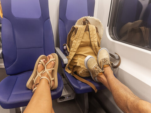 Selfie ugc of the feet of a tourist couple on the train seats