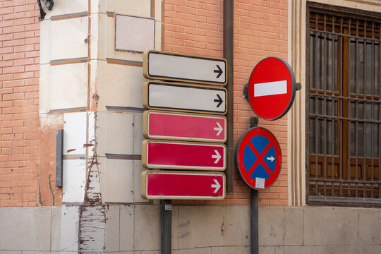 Multiple Directional Traffic Signs on a Building Corner in Urban Area