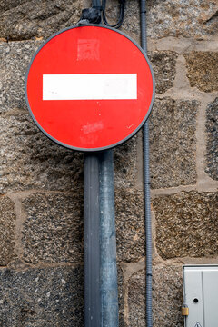 No Entry Sign Mounted on a Stone Wall in Urban Setting
