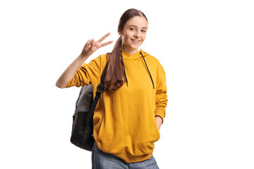 Female teenager gesturing a peace sign