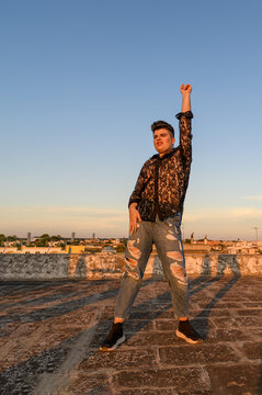 Expressive non-binary person dancing on the roof