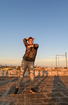 Non-binary person dancing and enjoying on the roof
