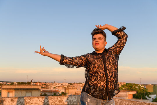 Portrait of non-binary person on the roof at sunset